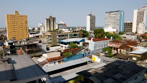 Static-rooftop-establishing-shot-of-Manaus,-Brazil-with-the-city-in-the-foreground-and-the-Amazon-River-on-the-horizon