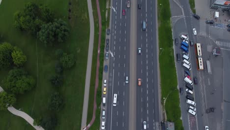 A-drone-video-of-cars-driving-down-a-major-road-in-Warsaw,-Poland