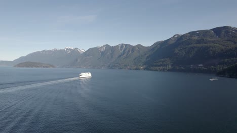 Vista-Aérea-De-Un-Barco-Que-Navega-En-El-Océano-Canadiense,-Servicios-De-Ferry-De-Columbia-Británica-En-Vancouver,-Crucero-En-La-Bahía-De-Las-Montañas-Con-Un-Impresionante-Paisaje-Marino-Natural-No-Contaminado