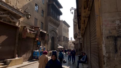 Egyptian-people-walking-in-pedestrian-street-of-old-Cairo-historic-town-center,-Egypt