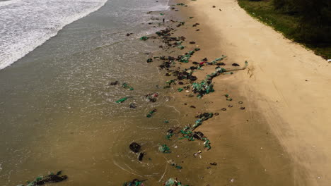 Washed-out-fishing-net-on-sandy-Vietnam-coastline-after-typhoon,-aerial-view