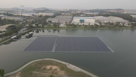 Floating-solar-panels-on-lake,-alternative-power-generator,-Aerial-upwards-and-tilt-down