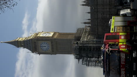 A-vertical-video-of-the-beautiful-Big-Ben-clocktower-from-Parliament-Square,-the-scaffolding-being-removed-from-the-iconic-landmark-after-the-completion-of-the-restoration-project,-London,-England