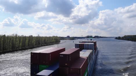 Container-Vessel-Sails-On-The-Oude-Maas-River-Under-Clear-Sky-In-Netherlands