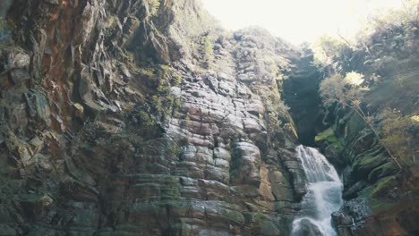 Beautiful-cave-waterfall-located-at-natural-park-in-slow-motion