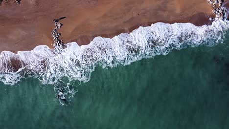 aerial-view-of-an-Italian-coastline,-morning-light,-bird's-eye-view-of-sea-waves
