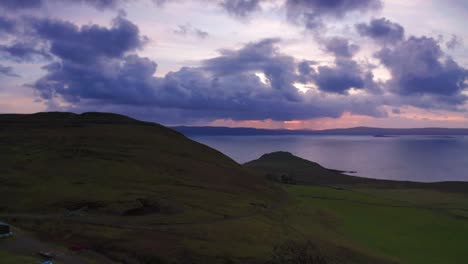 Aerial-Drone-sunset-flyover-fields-and-cliffs-near-Uig-Skye-Scotland-Autumn