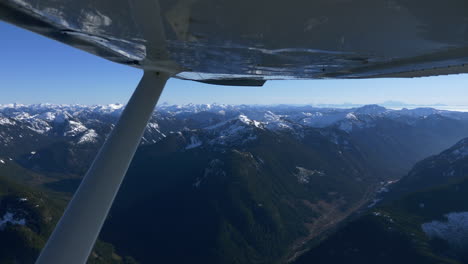 Aerial-view-of-Mountains-in-Whistler-region-with-snow-covered-summit-and-blue-sky-in-summer