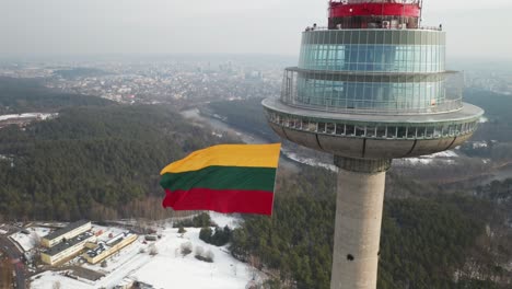 AERIAL:-Flag-Waving-on-Sunny-Winter-Day-on-Vilnius-Television-Tower
