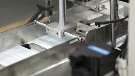 Medical-Mask-On-Production-Line---Putting-Earloops-At-Automated-Machinery---Close-Up-Shot