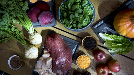 Selection-of-gourmet-meat-and-vegetables-cooking-ingredients-on-table