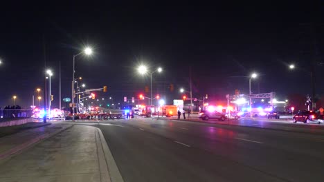 Police,-fire-truck-and-ambulance-emergency-lights-flashing-on-street-intersection