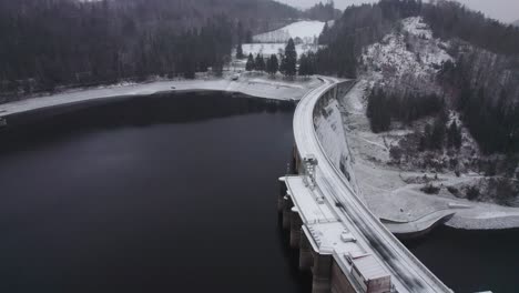 Water-retention-dam-with-hydroelectric-power-plant-in-winter-with-freshly-fallen-snow-in-the-morning