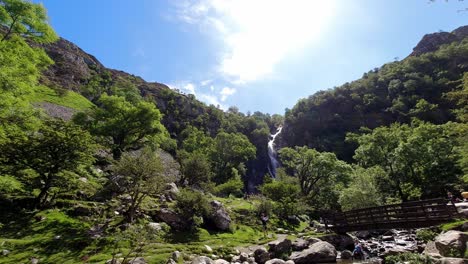 people-hiking-Aber-falls-Snowdonia-mountain-Welsh-national-park-waterfall-time-lapse