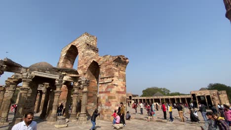 Tourist-gathered-outside-Qutub-Minar,-also-spelled-as-Qutab-Minar,-or-Qutb-Minar,-is-the-tallest-minaret-in-the-world-made-up-of-bricks