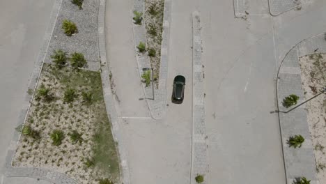 Drone-shot-of-a-car-driving-in-Eko-Atlantic-City-viewpoint-looking-into-the-Atlantic-ocean