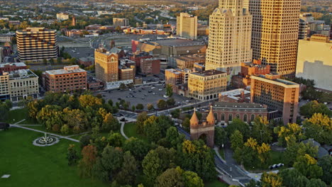 Hartford-Connecticut-Aerial-v17-birds-eye-view-overlooking-memorial-arch-at-bushnell-park,-tilt-up-reveals-downtown-cityscape-at-sunset-golden-hours---Shot-with-Inspire-2,-X7-camera---October-2021