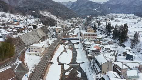 Aerial-View-of-Yamanouchi-Town-in-Nagano,-Snowy-Landscape-of-Japan