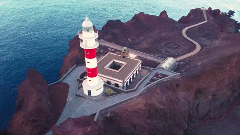 Drone-backward-pan-and-spin-view-of-lighthouse-at-La-Punta-de-Teno-in-Tenerife
