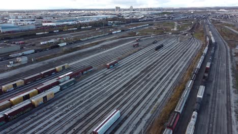 Aerial-view-passing-above-MacMillan-railroad-yard-tracks-Vaughan,-Canada,-dolly-left