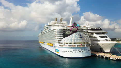 Drone-shot-of-the-Wonder-Of-The-Seas-Royal-Caribbean-cruise-ship-docked-in-Cozumel,-rotating