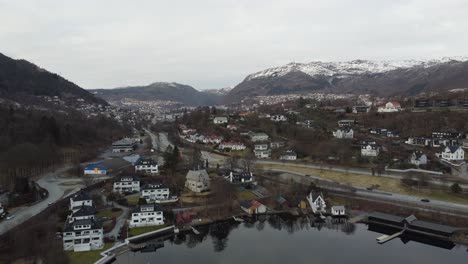 Bergen-city-aerial-view-seen-from-Nordasvatnet-lake-and-Krambua-looking-against-Danmarksplass-and-city-center---Ulriken-mountain-in-background---Evening-aerial-Norway