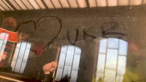 Someone-has-drawn-a-heart-and-UKR-for-symbol-of-LOVE-UKRAINE-on-a-train-window---train-full-of-refugees-escaping-the-war