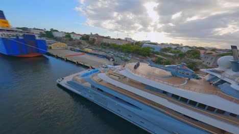 Aerial-fpv-flight-showing-luxury-Yacht-with-private-Helicopter-docking-at-Port-Of-Don-Diego,Dominican-Republic