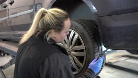 A-female-mechanic-checking-vehicle-tyres