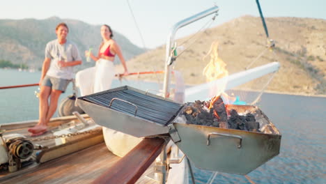 Slo-Mo-selective-focus:-Charcoal-grill-flames-on-rail-of-sailing-yacht