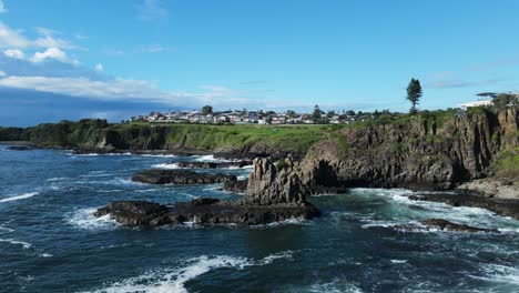 Stunning-sculptural-forms-of-a-towering-basalt-rock-formation-above-a-rugged-ocean-coastline