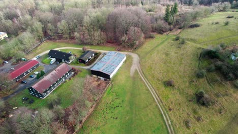 Drone-flying-over-small-rural-farm-area-in-Bristol-outskirts-surrounded-by-countryside