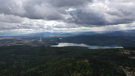 Gloomy-Scenery-Of-Lake-And-Vast-Forest-On-A-Cloudy-Day---aerial-shot