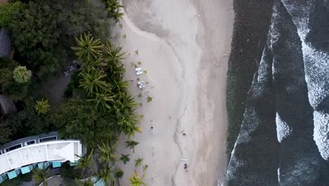 Top-down-birds-eye-aerial-drone-view-of-a-fancy-resort-hotel-on-Sayulita-main-beach-in-Mexico