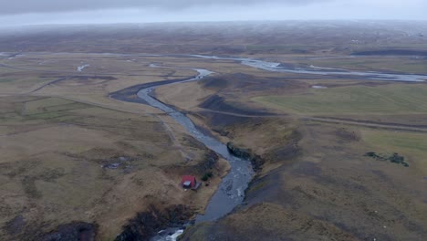 Aerial-drone-shot-of-Sela-Rriver-running-in-a-magnificent-landscape-of-Iceland-during-grey-clouds-at-sky