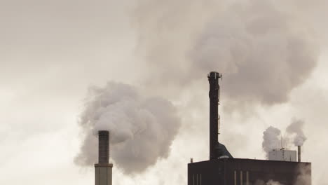 ZOOM-IN---Factory-chimneys-with-copy-space-billowing-out-smoke