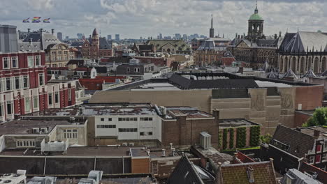 Amsterdam-Netherlands-Aerial-v19-low-level-pull-out-shot-capturing-historic-dutch-architectures,-buildings-and-houses-across-binnenstad-and-grachtengordel-neighborhoods---August-2021