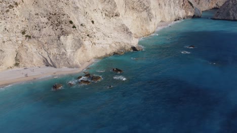 Aerial:-Porto-Katsiki-sea-beach-with-rocky-cliff-at-Lefkada,-Greece---drone-tracking-shot