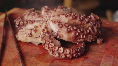 Slow-motion-handheld-shot-around-a-freshly-boiled-soft-bodied-and-eight-legged-molluscs-octopus-with-piping-hot-steams