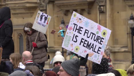 Protester-holding-up-a-handmade-protest-sign-at-the-international-women's-march