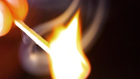 HD-Super-slow-motion-cinematic-macro-shot-of-a-match-being-lit,-in-a-dark-room
