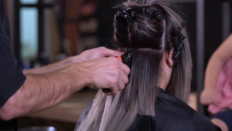 Hair-extension-installation-in-a-salon-by-a-hairdresser