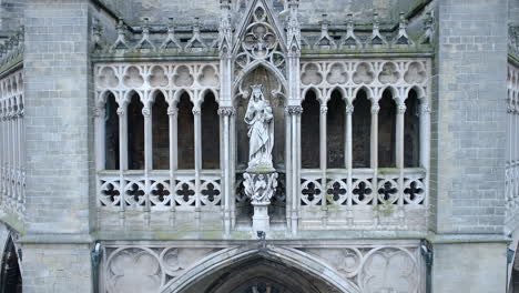 Holy-Saint-Mary-Statue-on-Gothic-Catholic-Cathedral-Facade,-Dolly-In