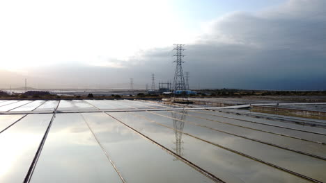 Aerial,-industrial-salt-field-reflecting-sky-from-surface