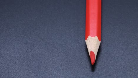 Red-colored-pencil-crayon-rotating-macro-shot,-zoom-close-up-video
