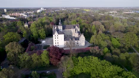 Flying-out-from-the-side-of-Wolfsburg-castle-surrounded-by-forest