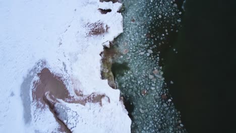 4K-Drone-of-waves-crashing-into-frozen-shoreline