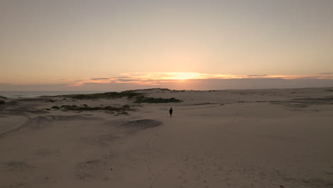 A-women-walking-in-a-patch-of-sand-in-Anna-Bay,-Australia