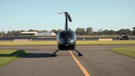 Pilot-walking-near-helicopter-at-airport