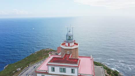 Finisterre-lighthouse-on-Rocky-cliff-by-the-Atlantic-Ocean,-pilgrimage-point,-end-of-the-old-world